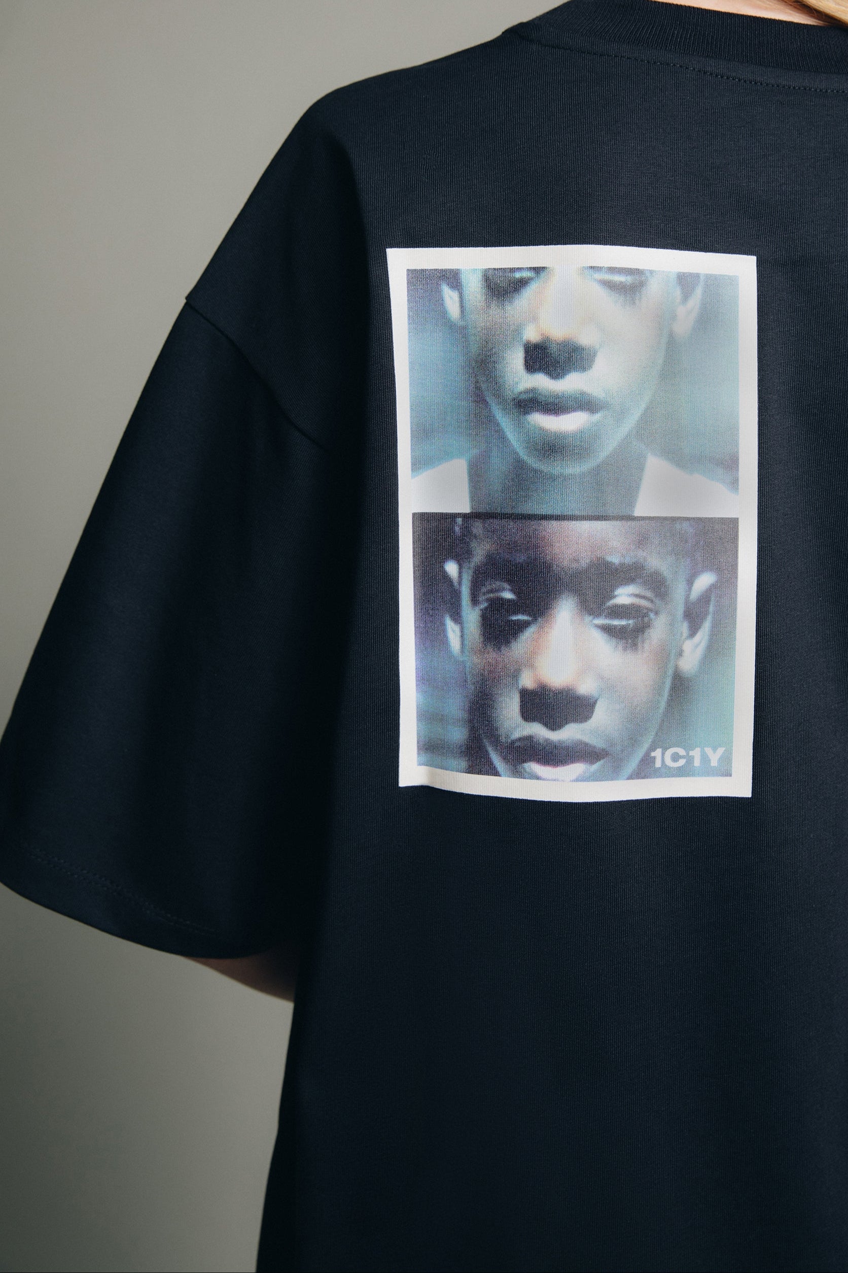 1c1y ss23 one t V organic cotton t shirt with print back detail shot of said print with a white frame. it's a split picture with the same african child showing a close up of the whole face and on the other half just the bottom. There's a 1c1y logo on the right bottom.