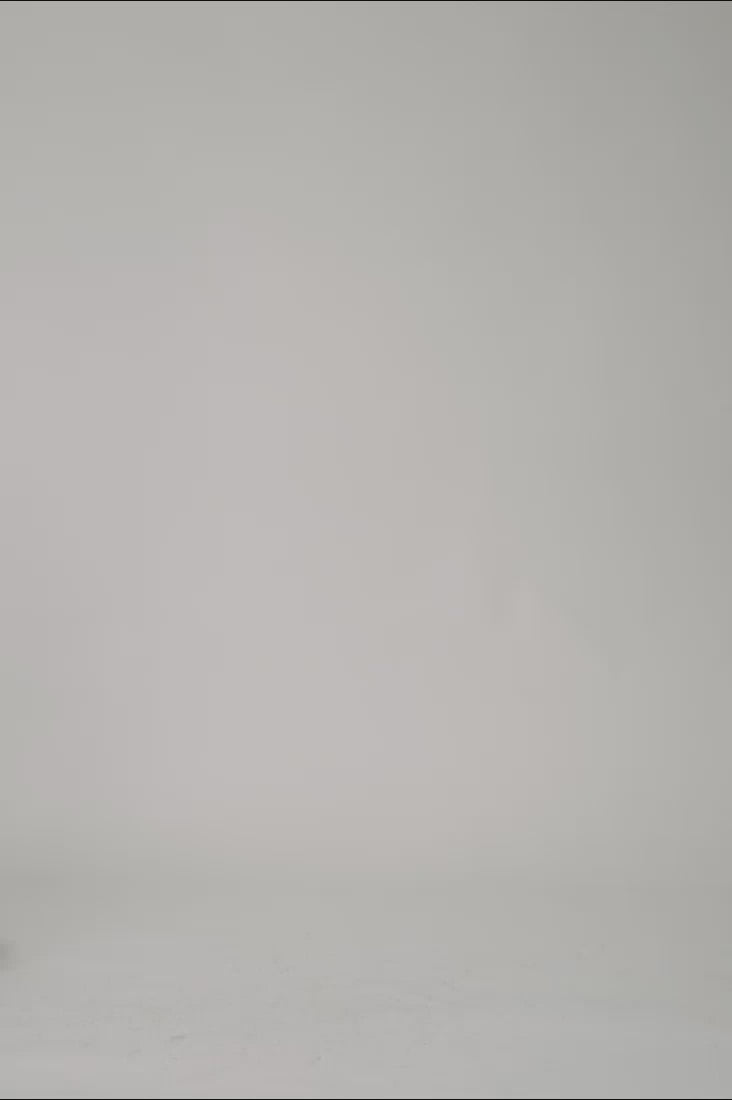 360 view web shop video of female model wearing Yul1a black ribbed merino turtleneck jumper cropped cut over high wasted suit pants before clean studio background 1c1y