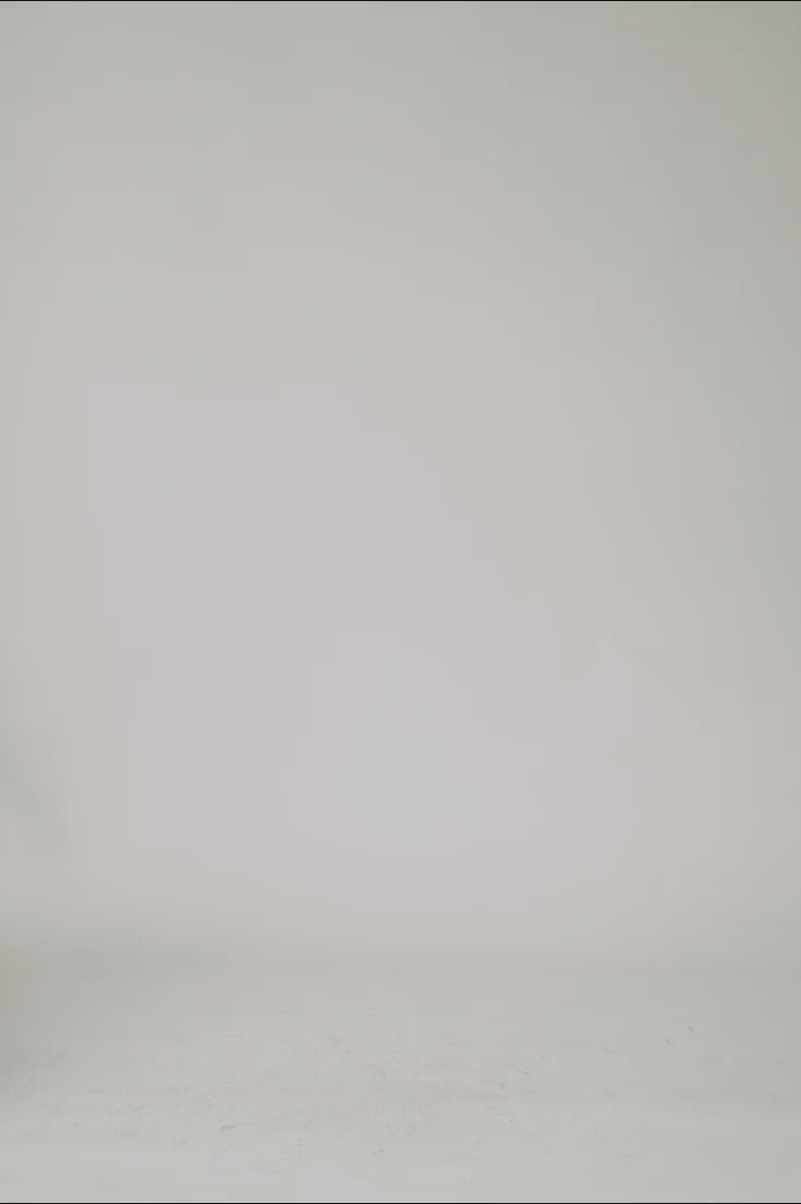 360 view web shop video of female model wearing one t oversized black organic cotton t shirt with reflective 1c1y logo print highlighted through light sleeves over elbow boxy fit before clean studio background 1c1y