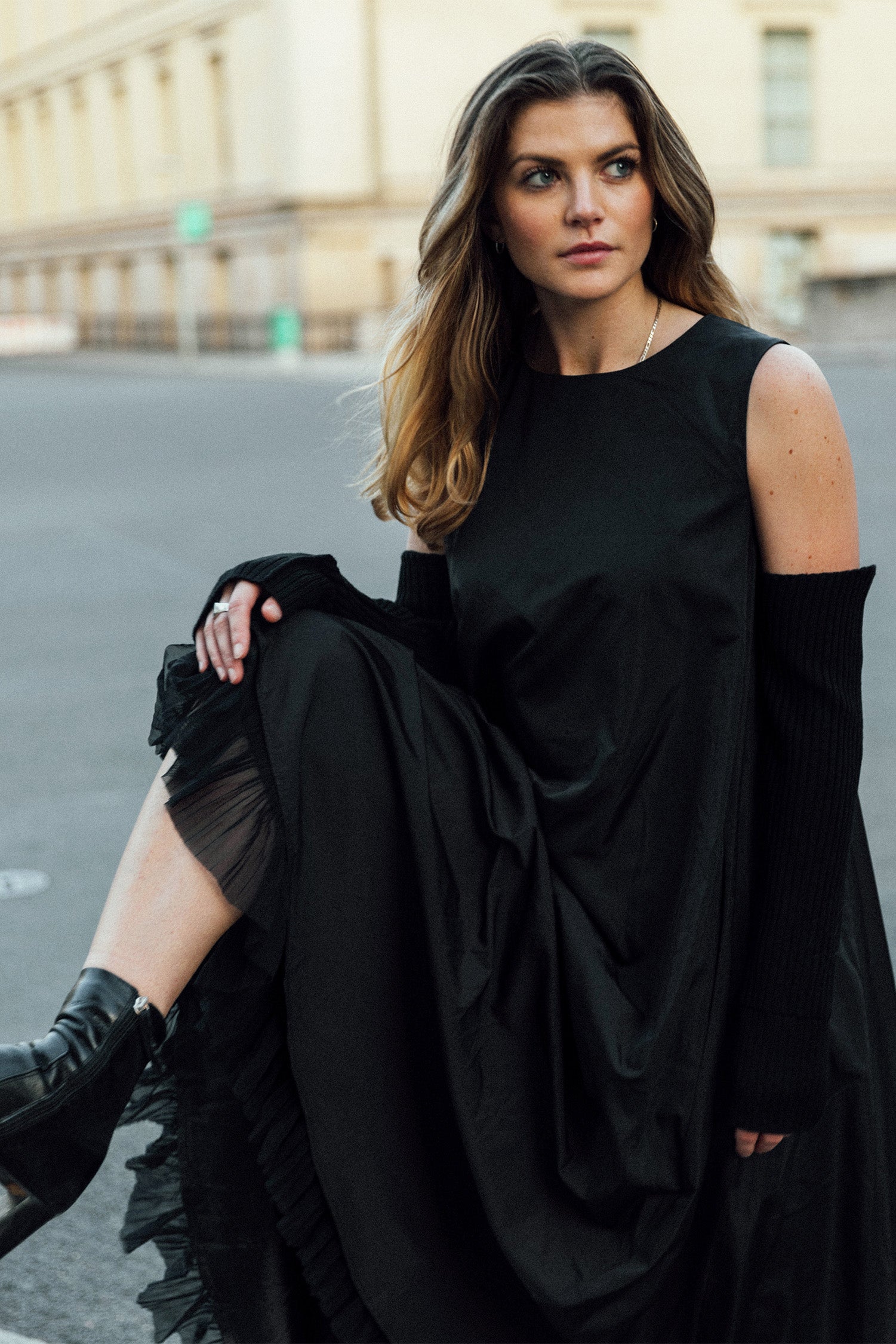 Model_wearing_recycled_nylon_dress_Leaning_putting_foot_up_a pole 1c1y