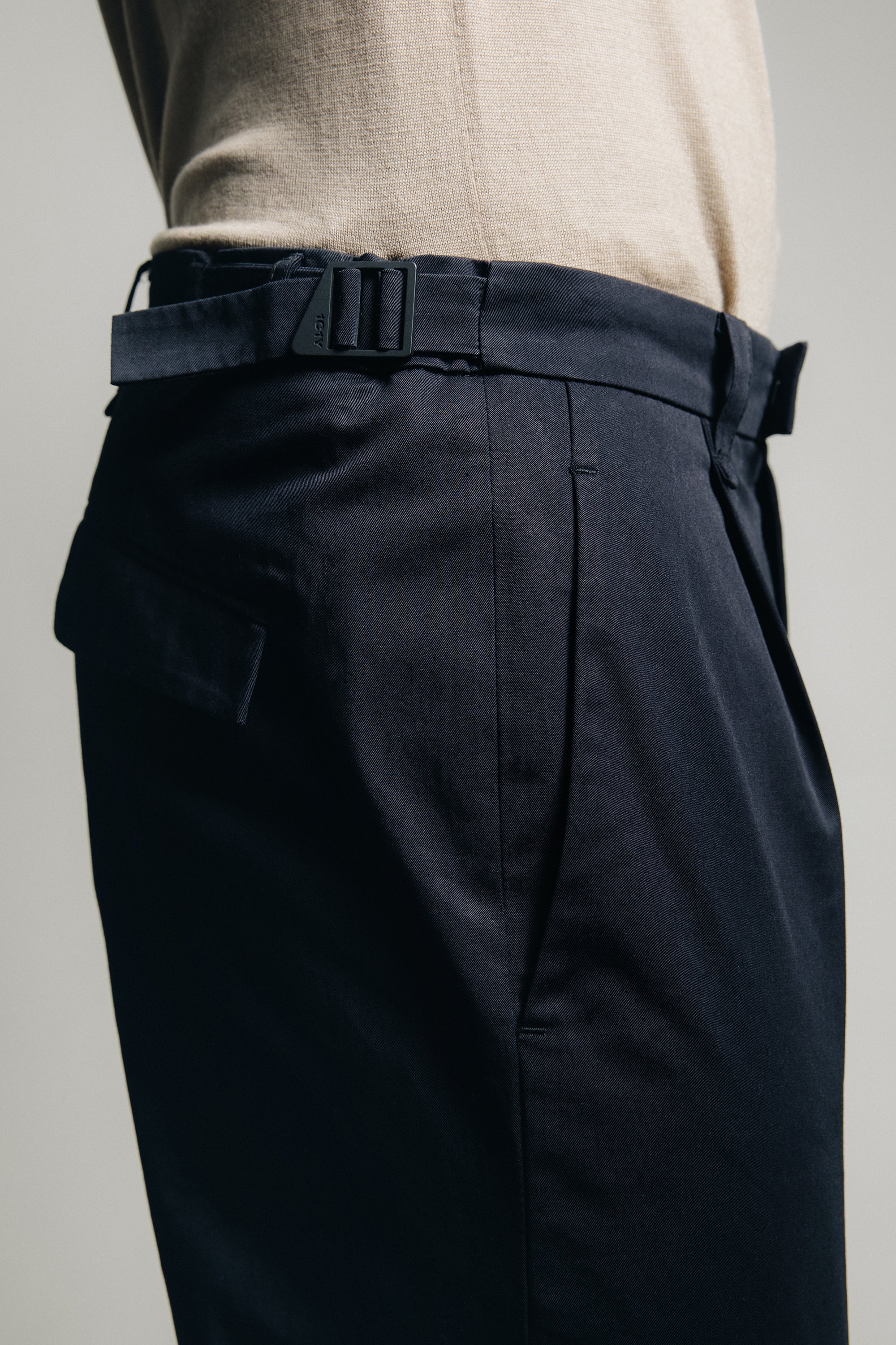 1c1y ss23 m1kyta II straight black suit with pleats organic cotton detail shot of side adjusters in triangle design deep pockets and pleats
