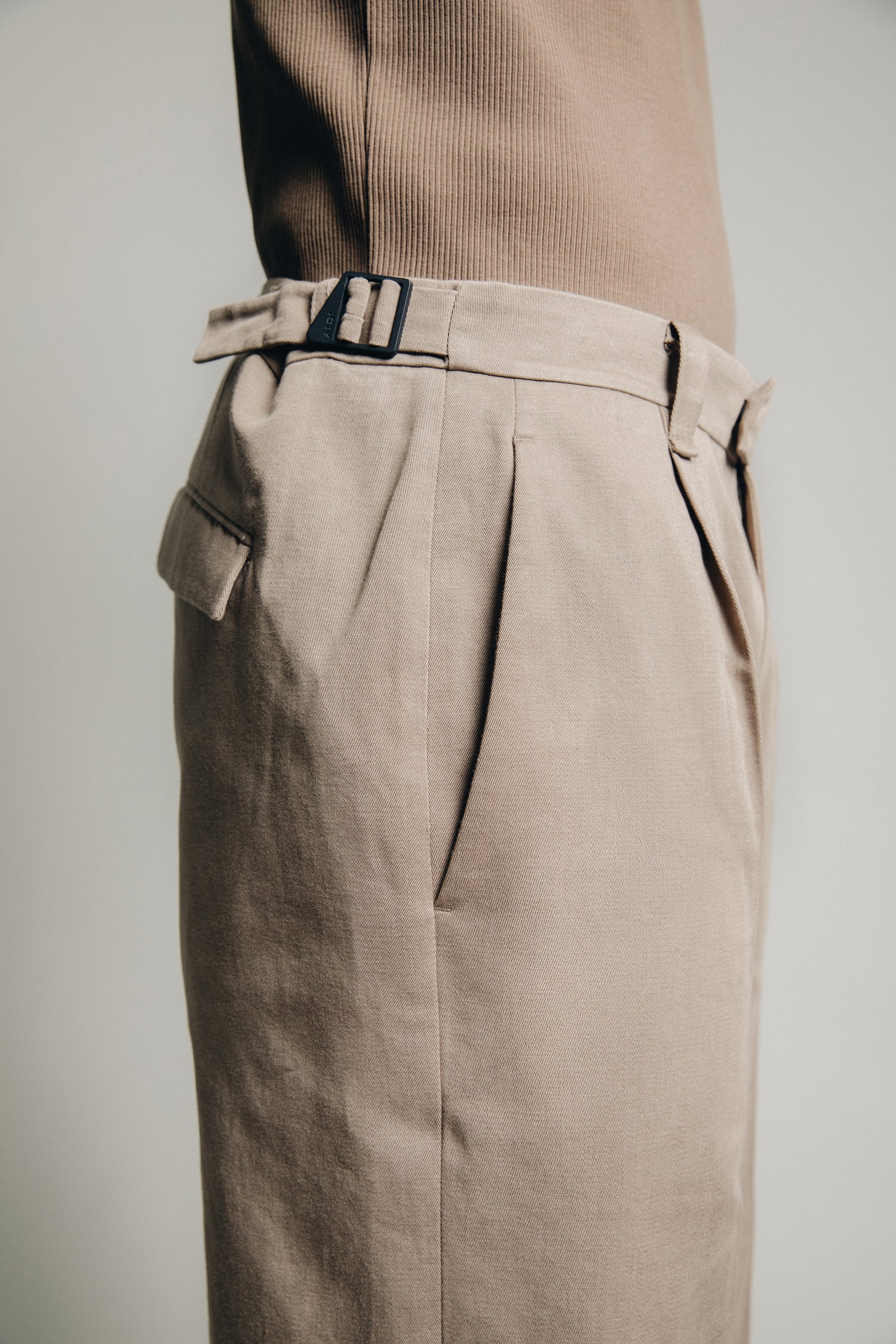 1c1y ss23 m1kyta straight suit pants in tobacco organic cotton side detail showing pleats back pockets and black side adjusters with new triangle detail