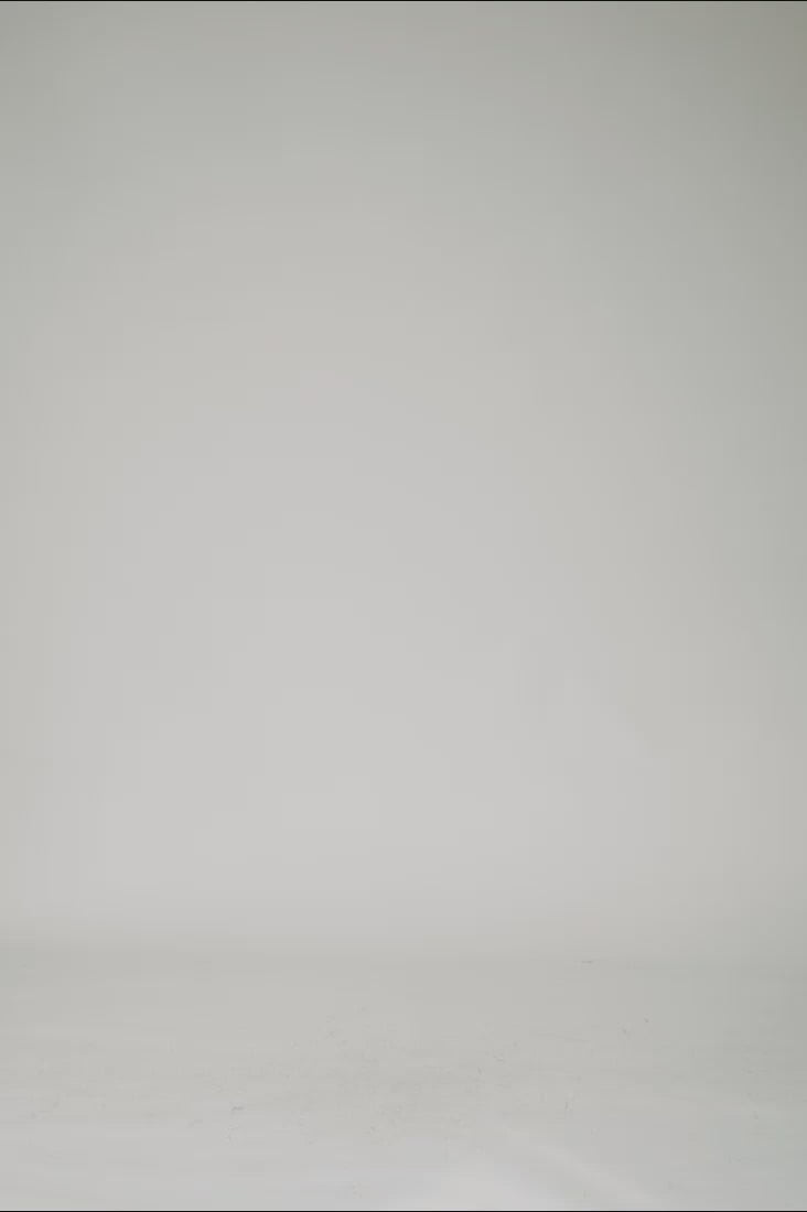 360 view webshop video of male model wearing 1c1y one hoodie reversible with velvet side showing reflective logo before clean studio background 1c1y